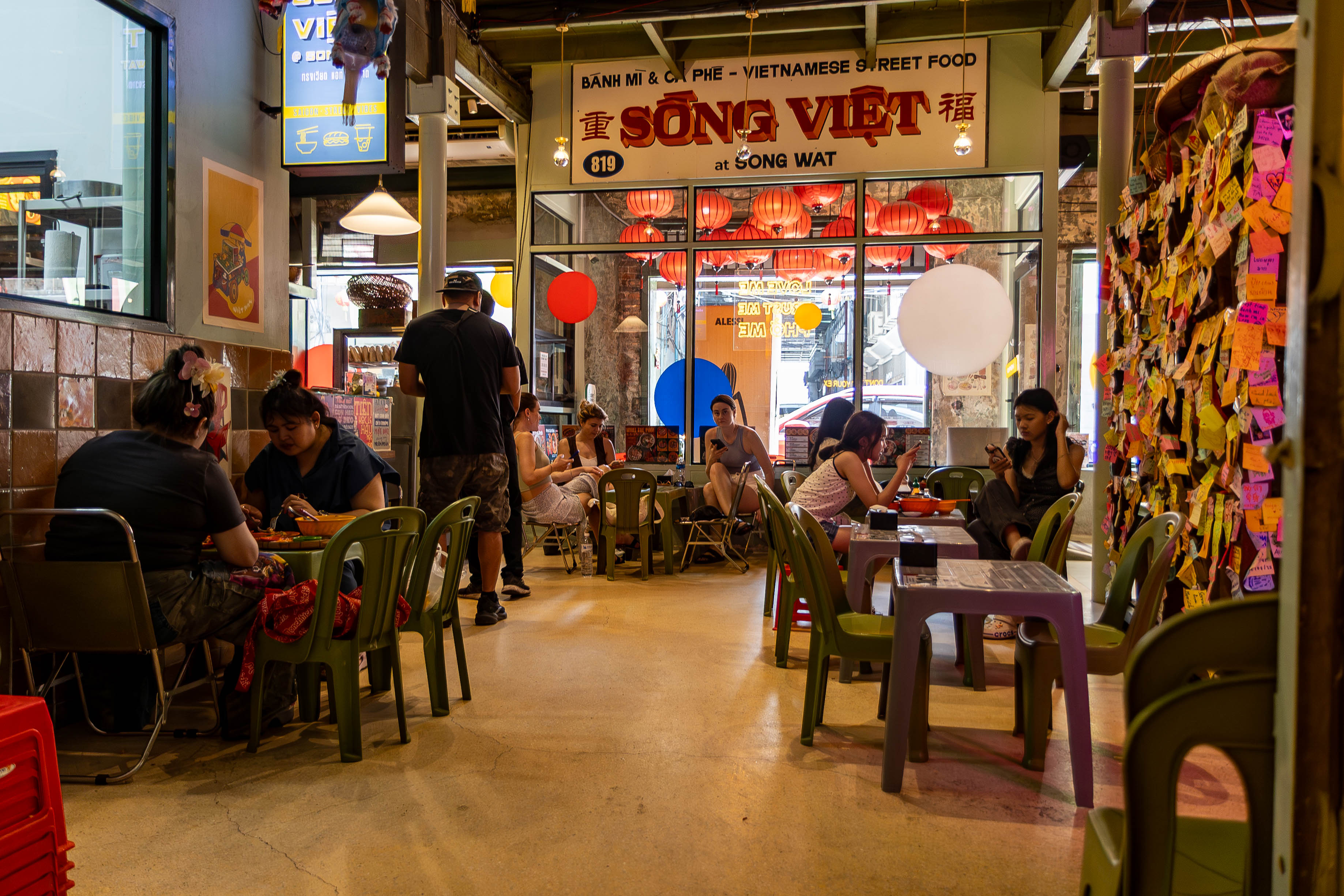 Song Viet at Song Wat interior on Song Wat Road Bangkok — plastic chairs, red lanterns and Bánh Mì & Cà Phê signage, authentic Vietnamese street food atmosphere Bangkok